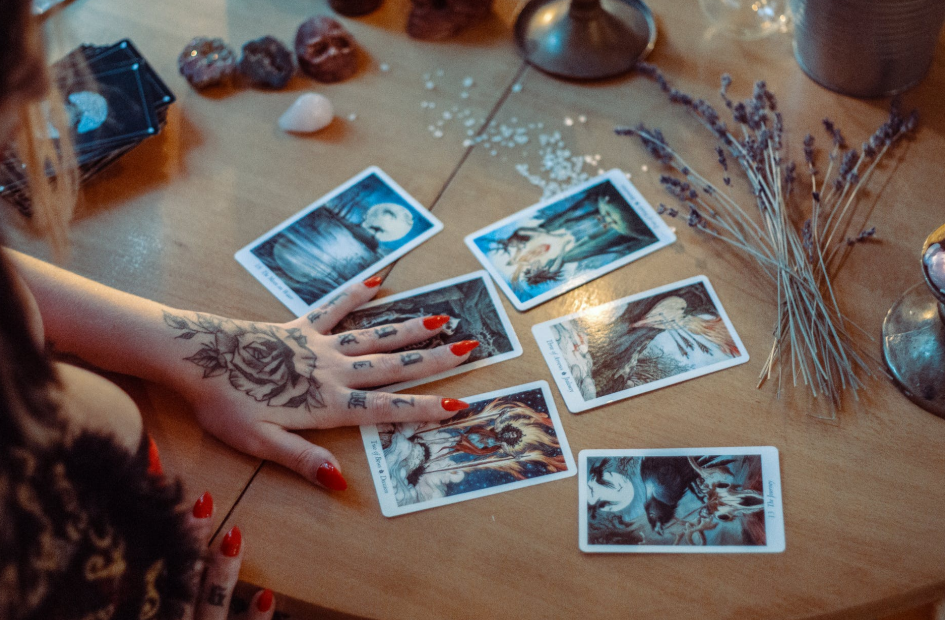 woman holding out tarot cards